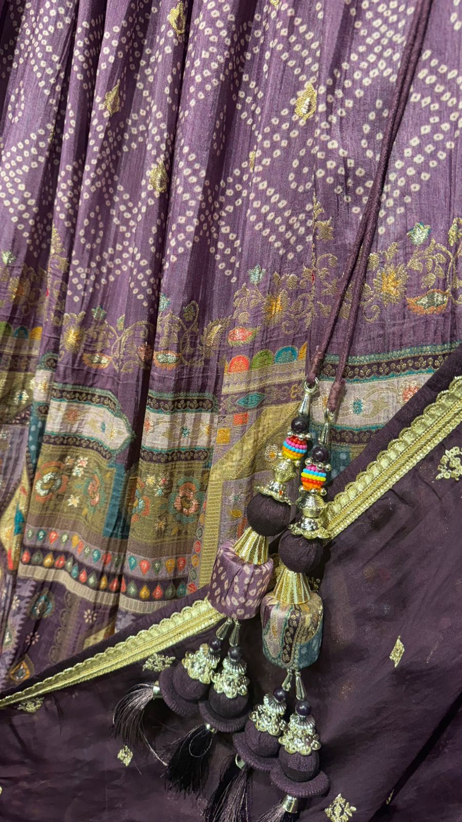 Plum Color Jamdani Silk (All weather silk) with mesmerising traditional weaving with jaipuri print along with intricate pearl & mirror handwork on blouse teamed up with organza dupatta in brinjal color to brighten up your wedding affairs