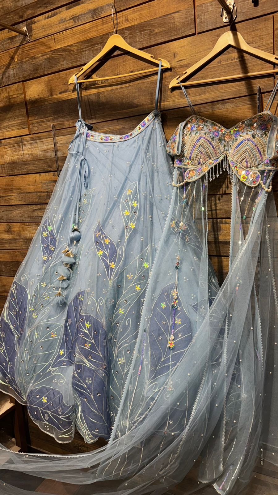 Imported Net Powder Blue Lehenga with beautiful handwork in pearl and appliqué teamed with full handwork blouse in beads with dropping shoulders along with two panels doing down to brighten up your ceremonial affairs