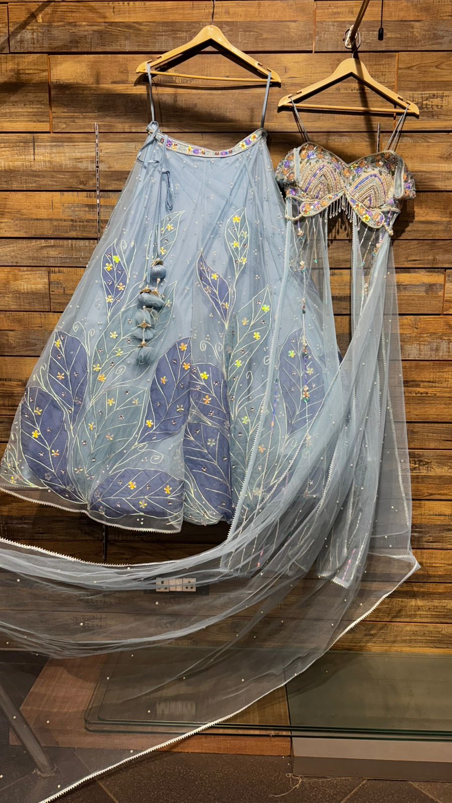 Imported Net Powder Blue Lehenga with beautiful handwork in pearl and appliqué teamed with full handwork blouse in beads with dropping shoulders along with two panels doing down to brighten up your ceremonial affairs