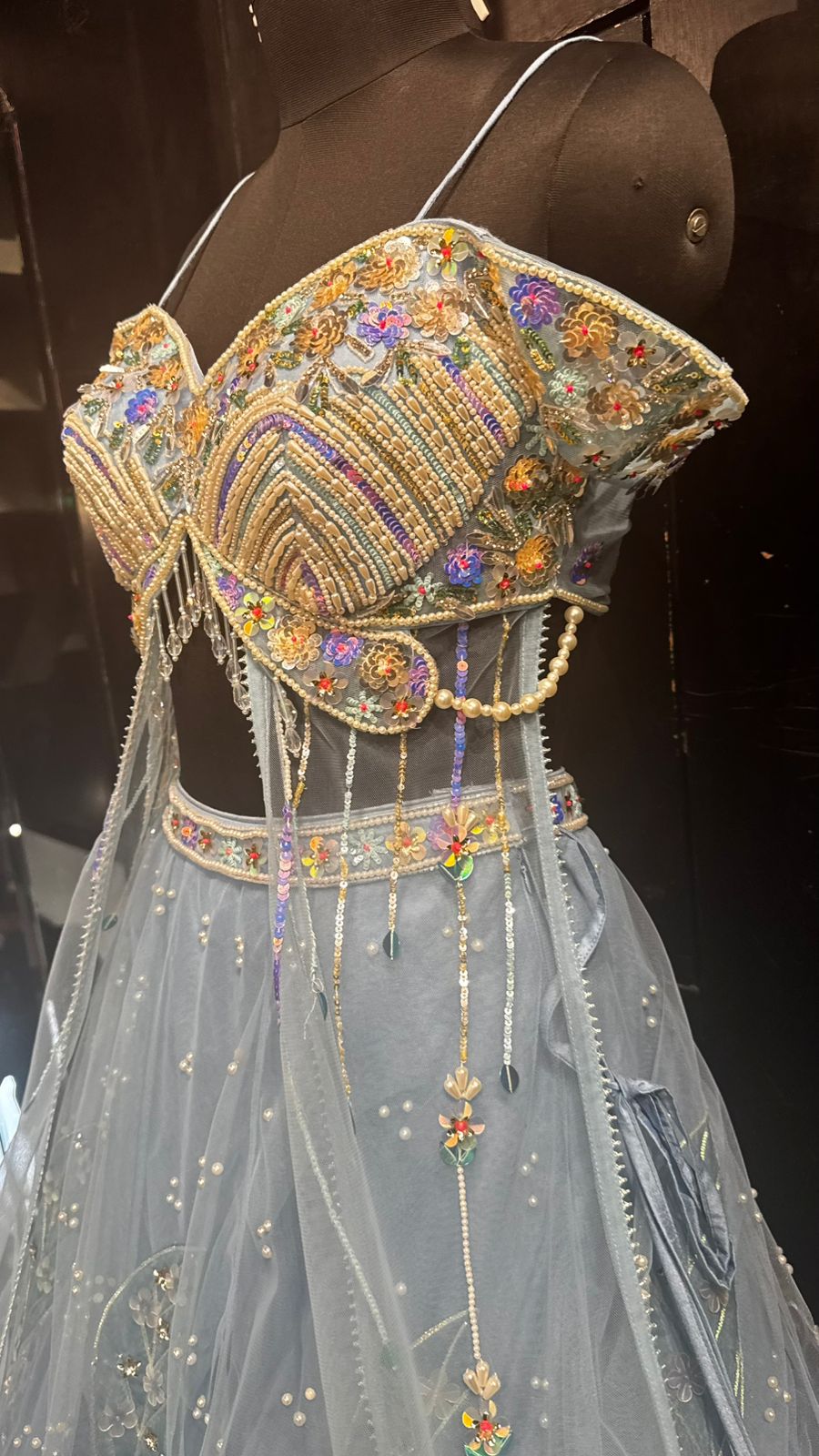 Imported Net Powder Blue Lehenga with beautiful handwork in pearl and appliqué teamed with full handwork blouse in beads with dropping shoulders along with two panels doing down to brighten up your ceremonial affairs