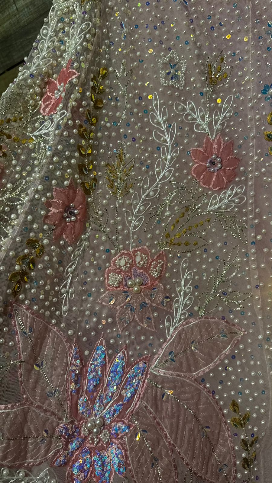 Imported Net Powder Pink Lehenga with beautiful handwork in pearl and beads teamed with full handwork blouse with tassels and dropping dupatta coming from behind the top for amazingly angelic appeal