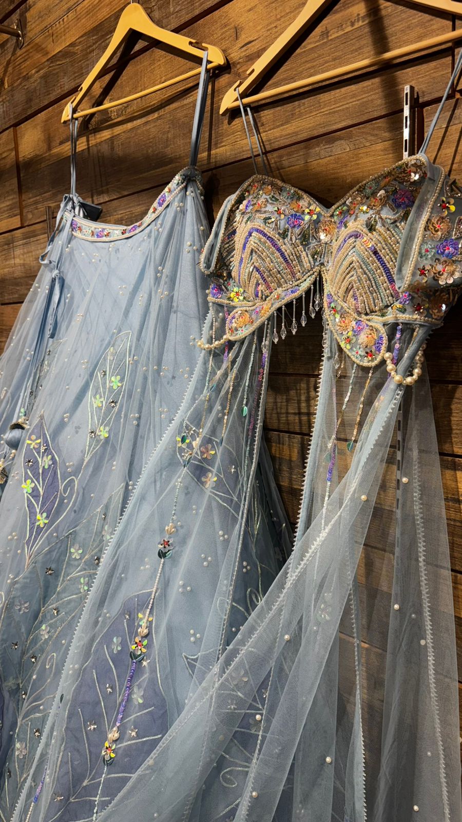 Imported Net Powder Blue Lehenga with beautiful handwork in pearl and appliqué teamed with full handwork blouse in beads with dropping shoulders along with two panels doing down to brighten up your ceremonial affairs