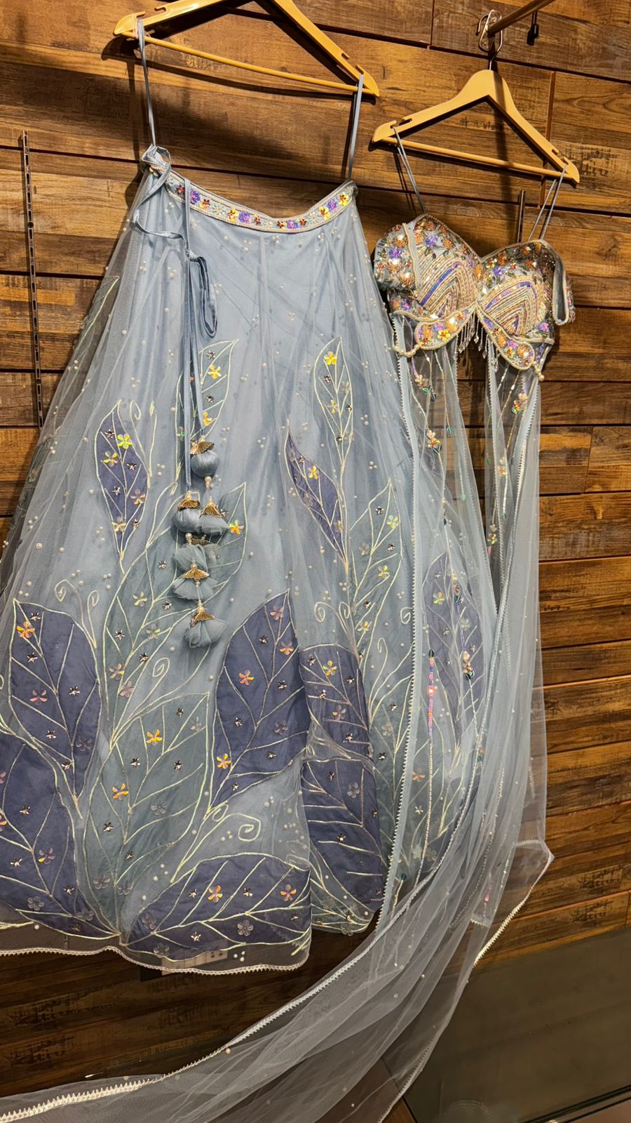 Imported Net Powder Blue Lehenga with beautiful handwork in pearl and appliqué teamed with full handwork blouse in beads with dropping shoulders along with two panels doing down to brighten up your ceremonial affairs