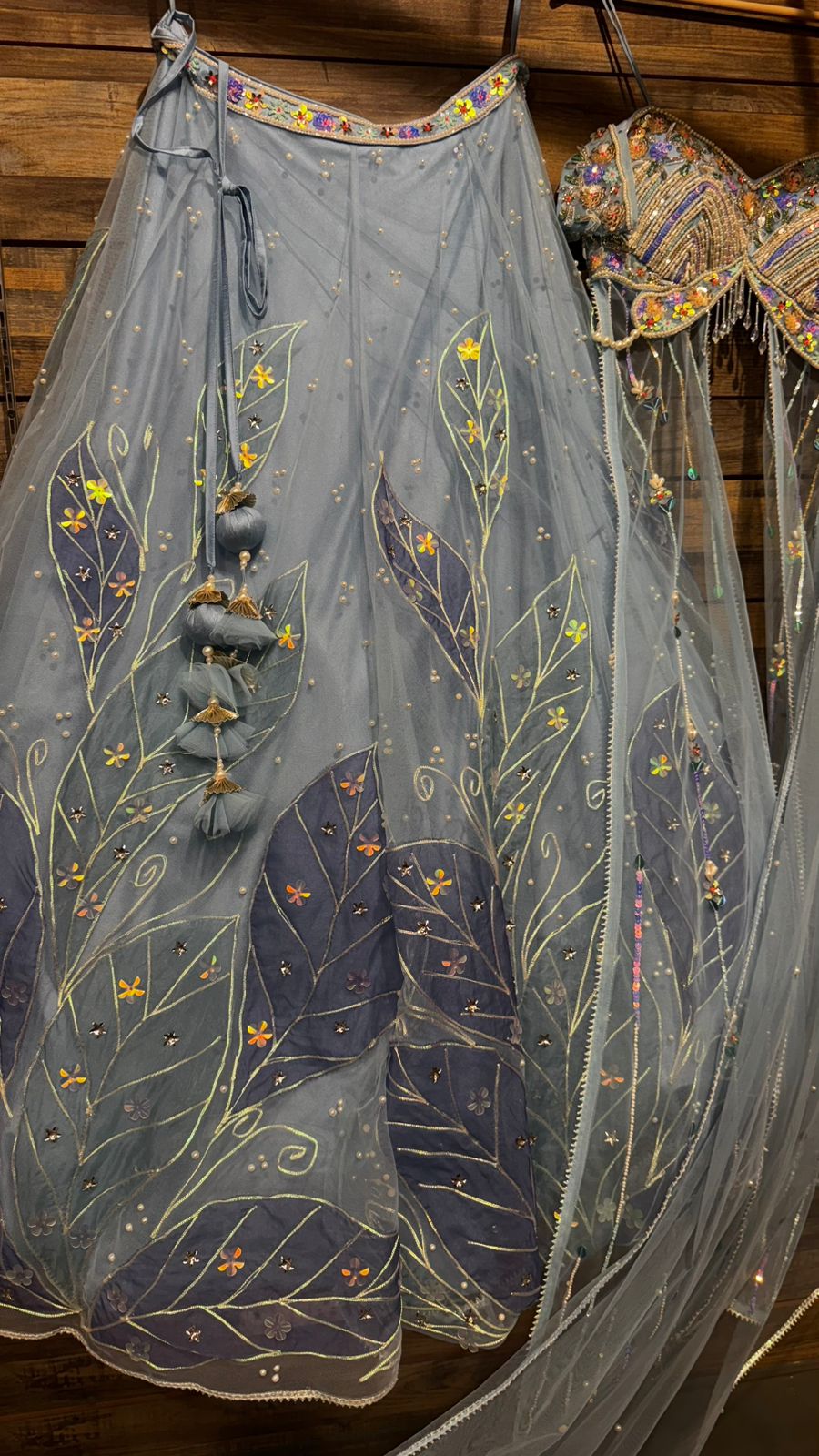 Imported Net Powder Blue Lehenga with beautiful handwork in pearl and appliqué teamed with full handwork blouse in beads with dropping shoulders along with two panels doing down to brighten up your ceremonial affairs