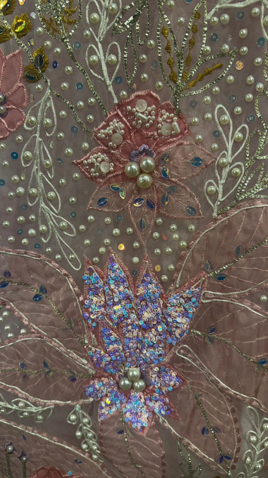 Imported Net Powder Pink Lehenga with beautiful handwork in pearl and beads teamed with full handwork blouse with tassels and dropping dupatta coming from behind the top for amazingly angelic appeal