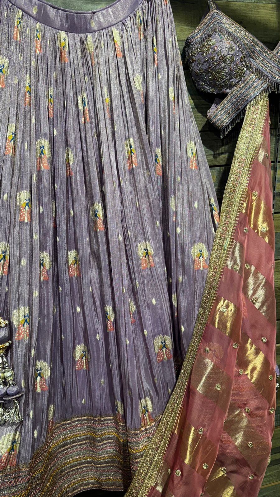 Lavender Color Lehenga with beautiful crush banarsi tissue fabric with banarsi weaving over the skirt and intricate handwork on blouse with criss cross neck pattern and organza dupatta with tissue patta weaving